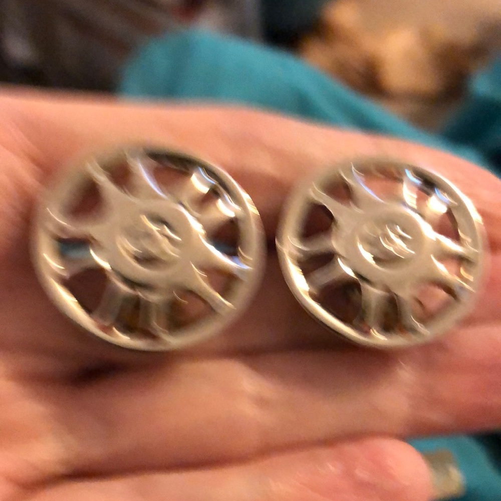 Bright silver clip on Chanel earrings.